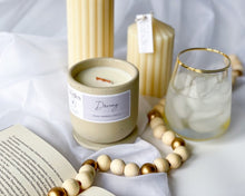 Load image into Gallery viewer, peach scented soy wax candle in cement vessel with wooden wick