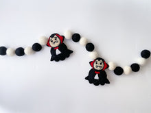 Load image into Gallery viewer, Dracula Halloween Garland. Halloween Decor made with black and white  felt pom poms and felted Draculas
