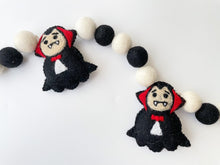 Load image into Gallery viewer, Dracula Halloween Garland. Halloween Decor made with black and white  felt pom poms and felted Draculas
